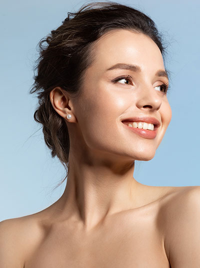 Fort Wayne Dermatology intro image, woman looking to her left on a blue background.